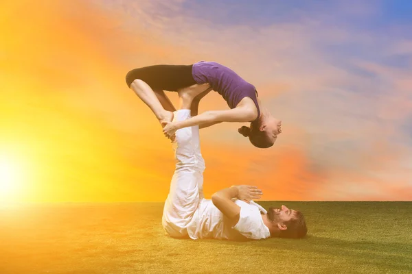 The two people doing yoga exercises