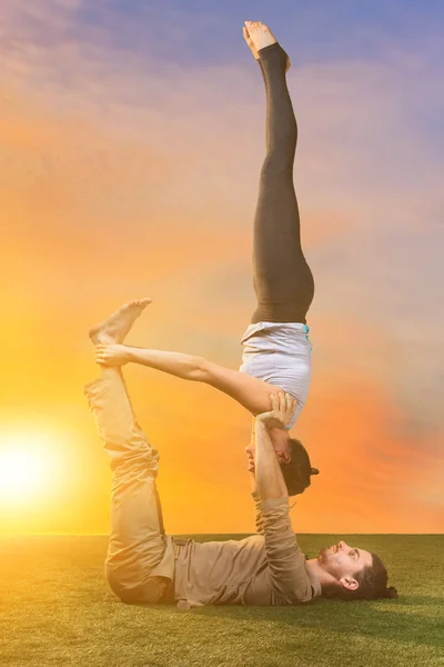 The two people doing yoga exercises