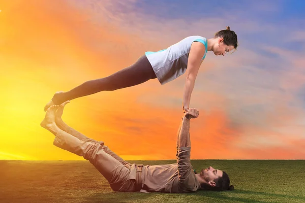 The two people doing yoga exercises