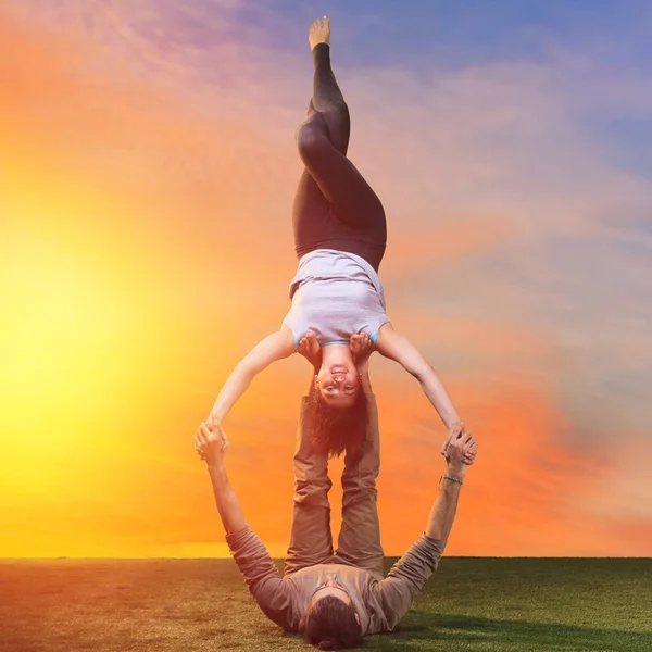 The two people doing yoga exercises