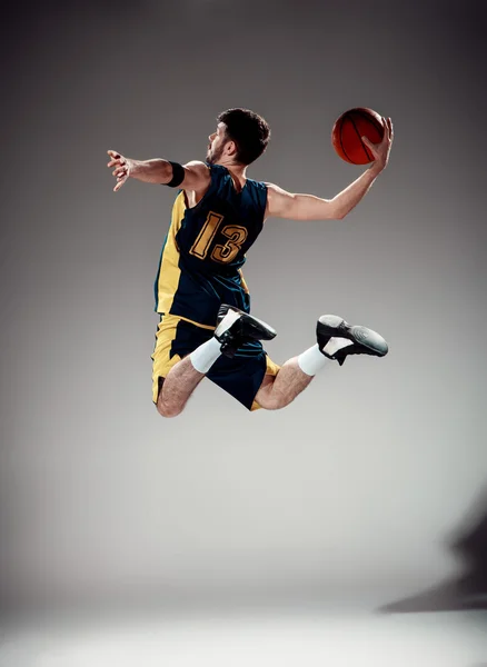 Full length portrait of a basketball player with ball