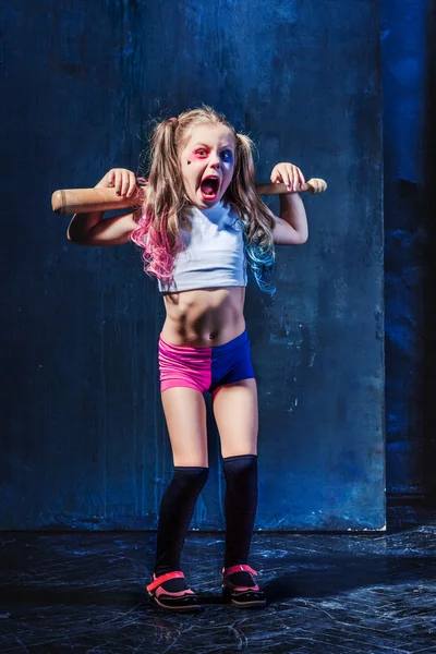 Little girl pointing in toy gun