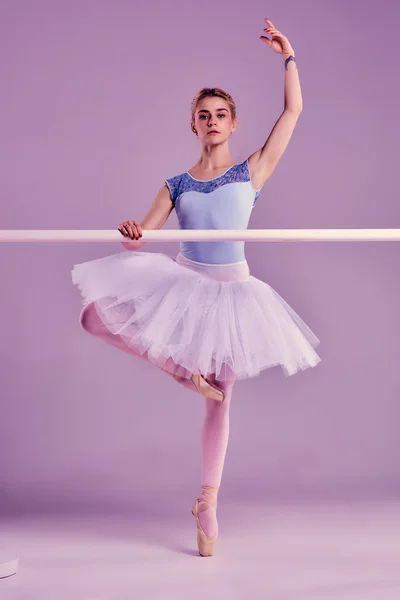 Classic ballerina posing at ballet barre