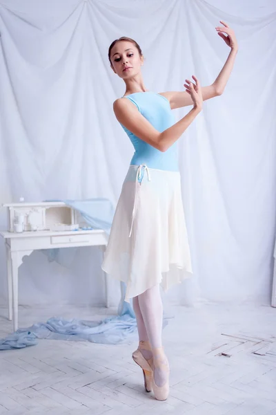 Professional ballet dancer posing on white