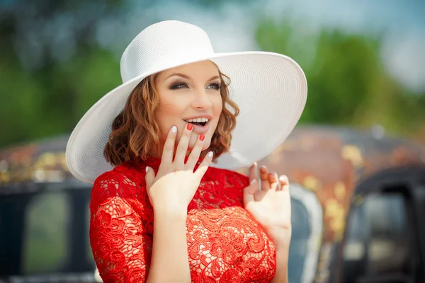 Beautiful woman in white hat expresses the joyful emotions