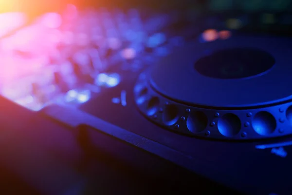 DJ mixer with light colored spotlights discos