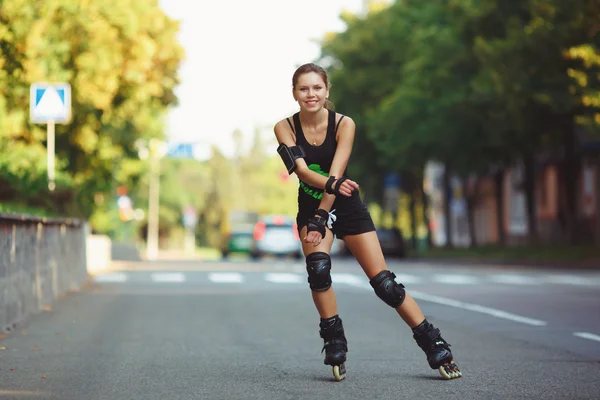 Woman in black sportswear roller skating
