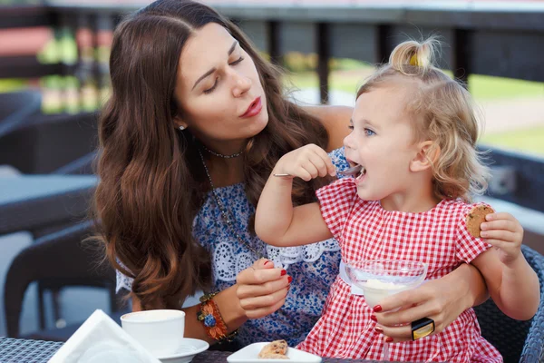 Happy mom and daughter eating ice cream