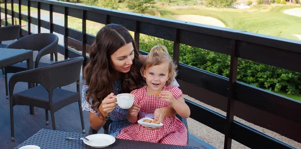 Happy mom and daughter eating ice cream