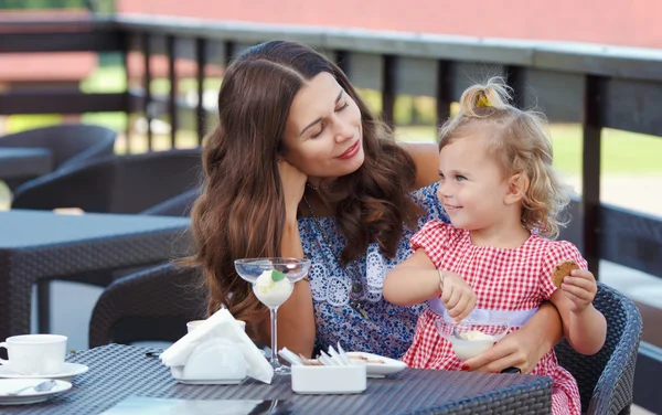 Happy mom and daughter eating ice cream