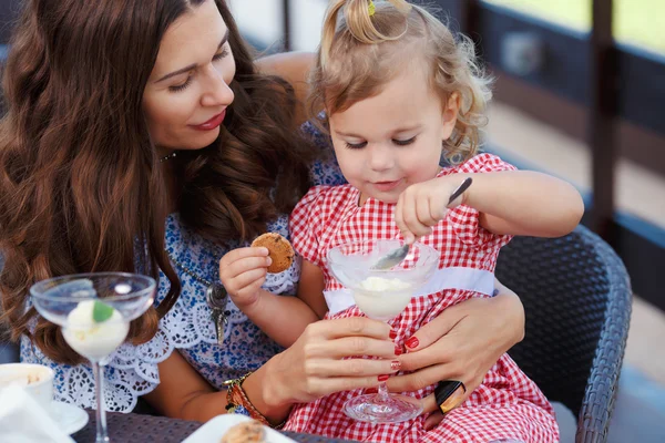 Happy mom and daughter eating ice cream
