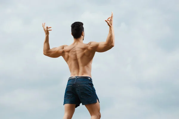 Muscular naked man from back