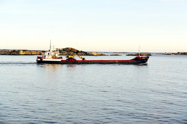Long black ship on the fjord
