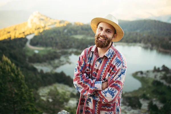 Man on hat smiling in nature