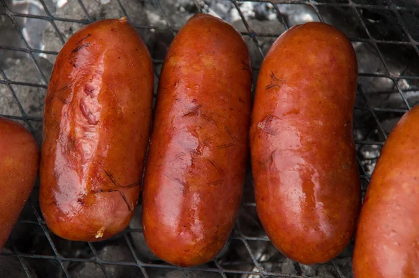 Delicious grilled sausages with smell of smoke