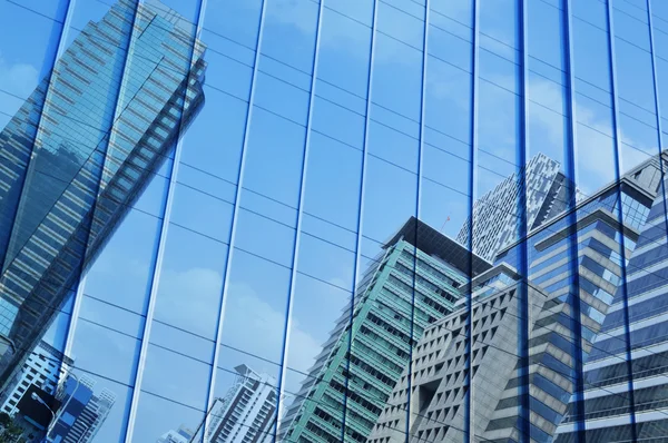 Reflect of modern city tower on metal wall, Bangkok Thailand