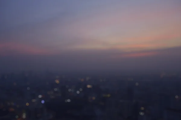Blurred aerial view of cityscape on warm light sundown