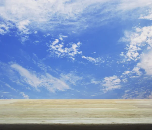 Empty wooden table over blue sky for your product display montag