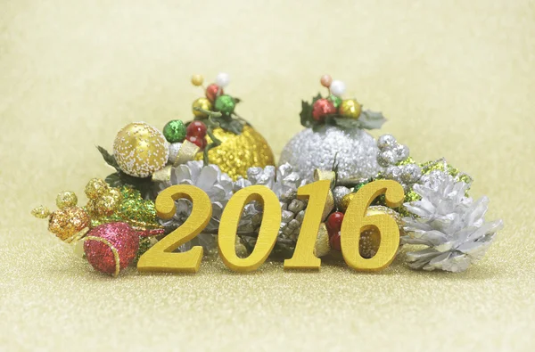 2016 new year decoration with christmas ornament on gold backgro
