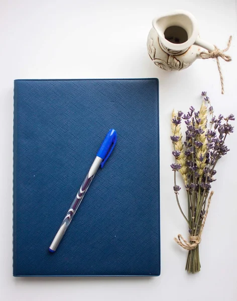 Copybook, pen and lavender isolated on white
