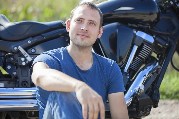 Young man on a motorcycle on a sunny day