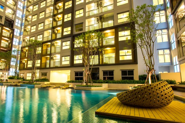 Night time of condominium and swiming pool