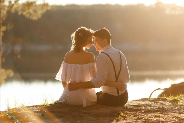 Loving couple kissing at sunset, summer outdoor