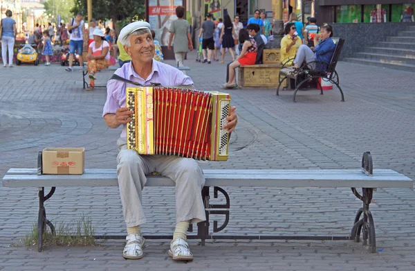 Man is playing bayan outdoor in Ulan Ude, Russia