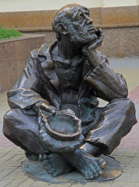 Street bronze sculpture of Beggar with cap in Chelyabinsk, Russia