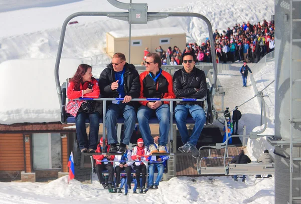 People leave sporting object by chairlift