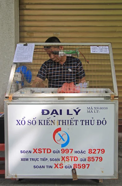 Man sells lottery tickets on street in Hanoi