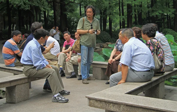 Chinese people are communicating in park of Shanghai, China