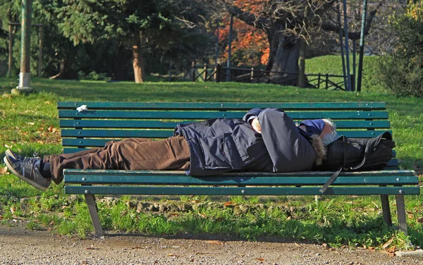 Man is sleeping in park of Milan