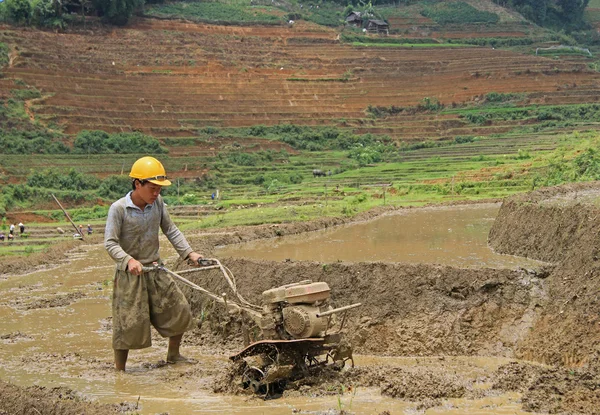 Man is working the soil by manual cultivator in village CatCat, Vietnam