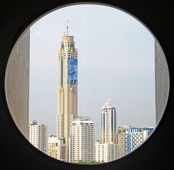 View to skyscrapers of Bangkok through circle window