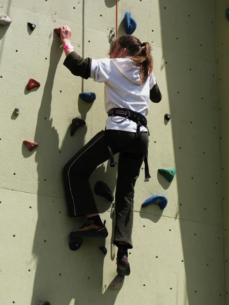 Lady climbing on practice wall