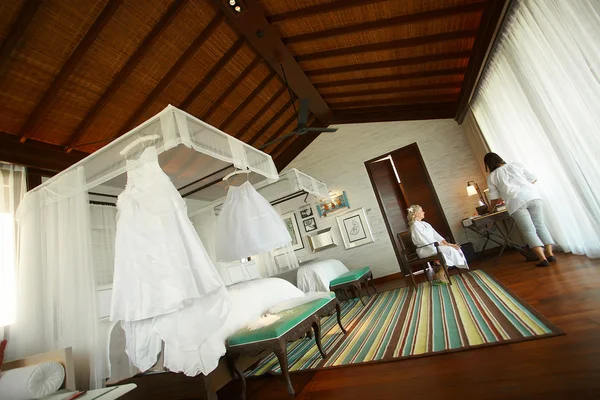 Groom and bride outfits in the hotel room.