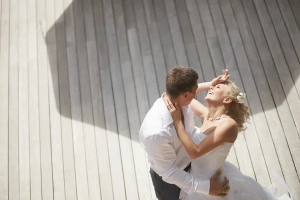 Lovely, gorgeous couple kissing close to pool area after wedding