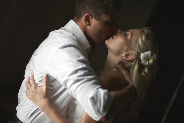 Beautiful young couple kissing with emotional embrace.
