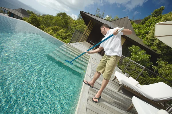 Swimming pool cleaner, professional cleaning service at work.