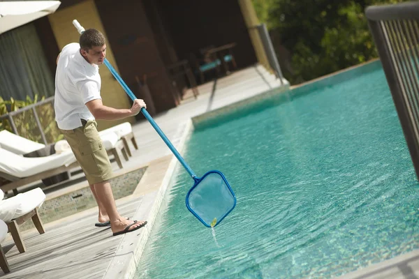 Swimming pool cleaner, professional cleaning service at work.