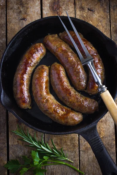 Roasted sausages on cast iron pan