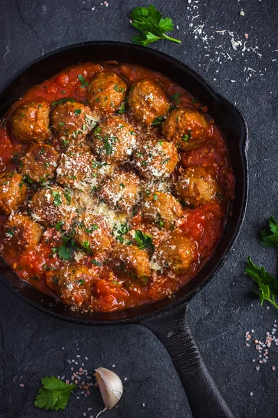 Beef  meatballs with tomato sauce and parmesan cheese in pan