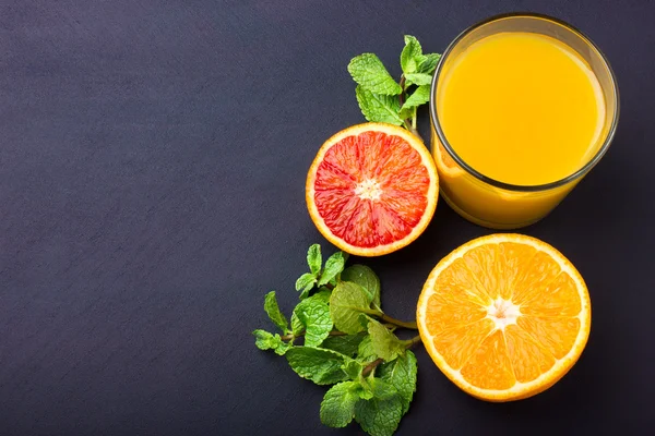 Fresh orange juice on dark background