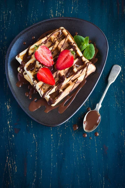 Belgian waffles with fresh berries and chocolate sauce