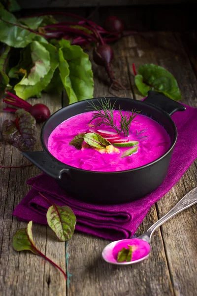 Beetroot cream soup on rustic background