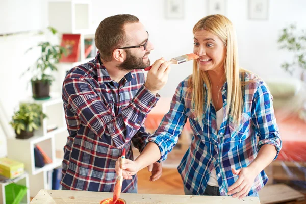 Young couple painting furniture at home