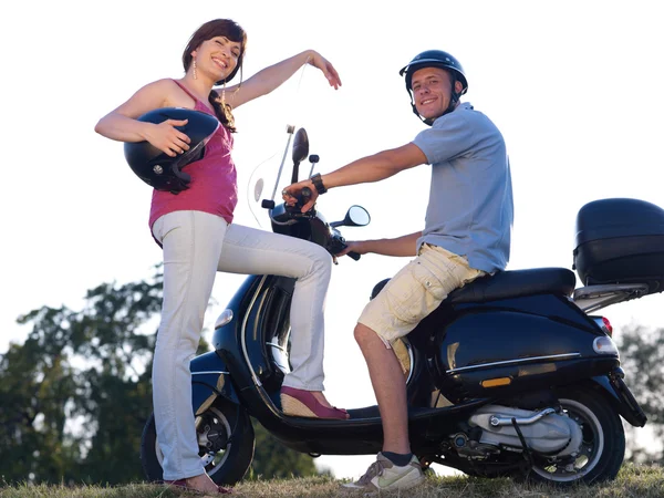 Young man and woman on motorcycle