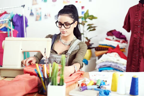 Designer working on sewing machine