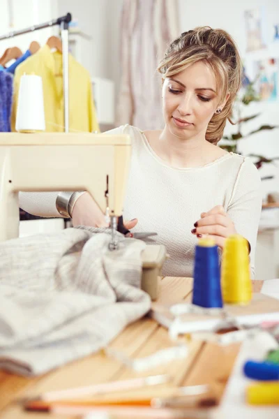 Designer working on sewing machine